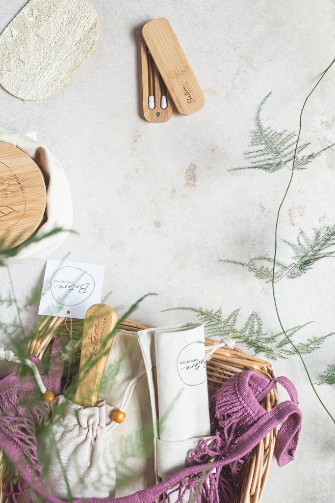 Flatlay of eco-friendly hygiene products in a basket on a white surface, promoting sustainability.